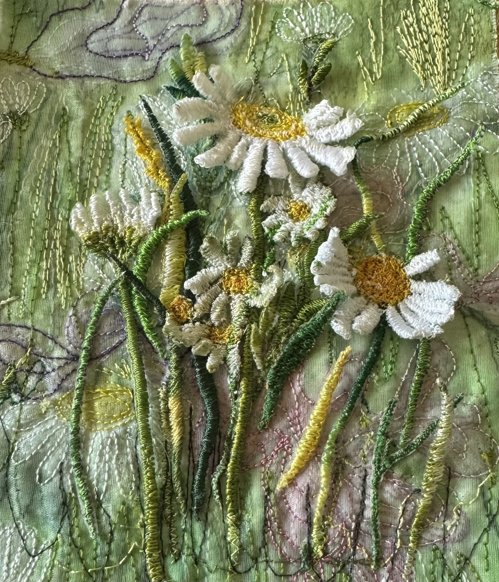 White daisies stitched in raised thread against a pale green ground