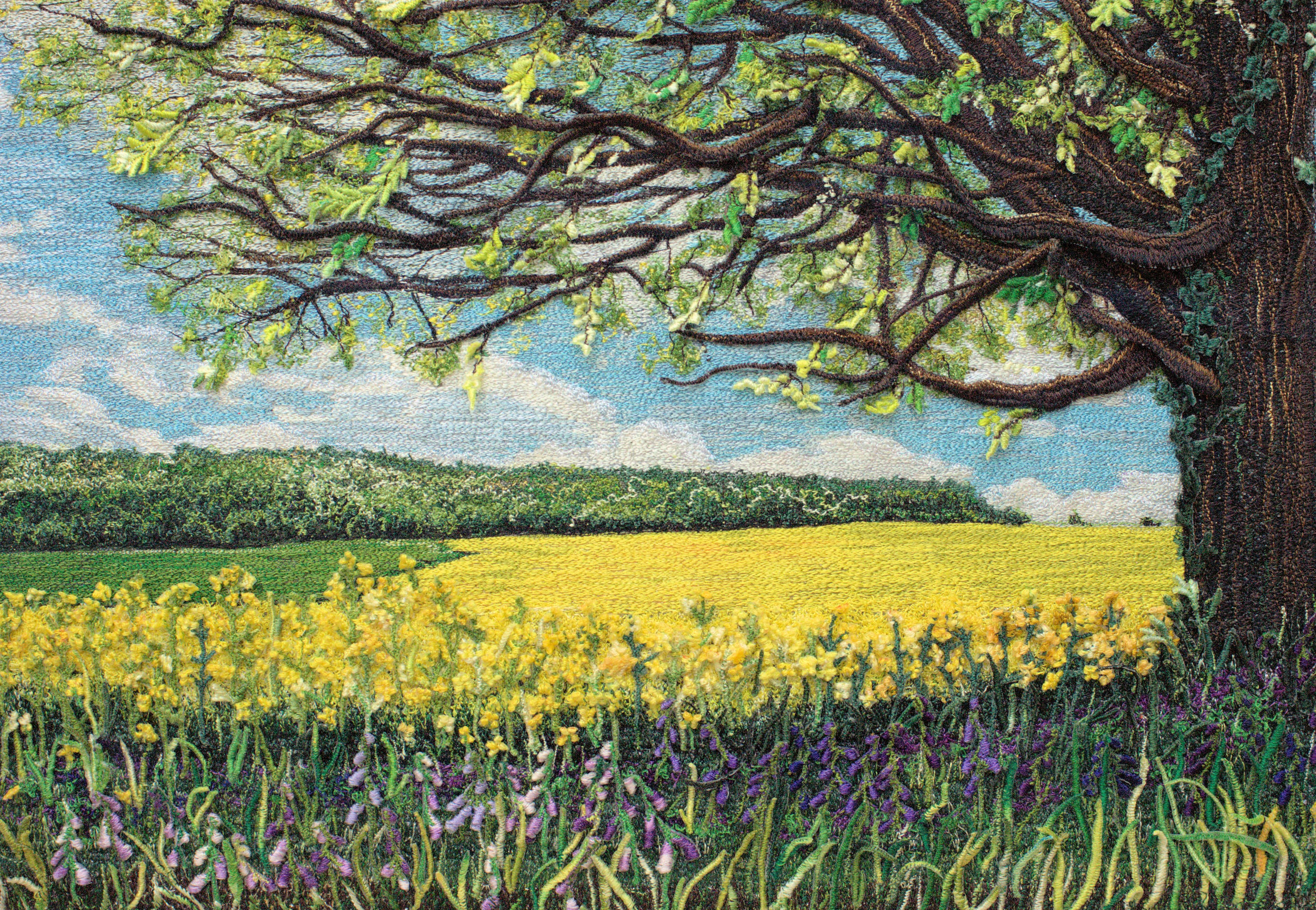 Expanded detail of a thread painting, showing stitched branches and leaves